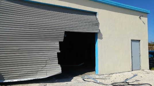 damaged roll up door after hurricane